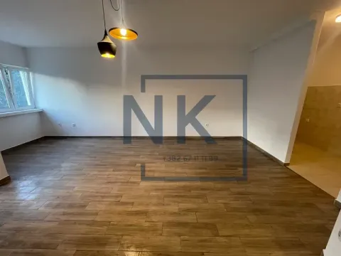Empty room with wooden flooring and pendant lights. - image 6