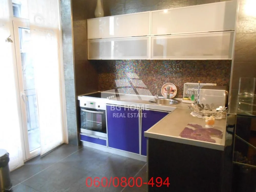 Modern kitchen with built-in appliances and a breakfast bar.