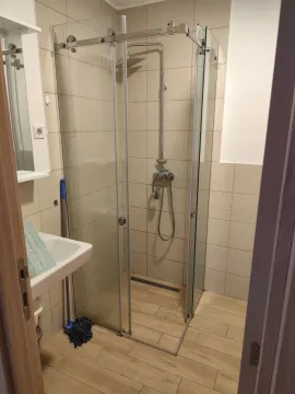 Bathroom with a shower cabin and a washbasin. - image 5