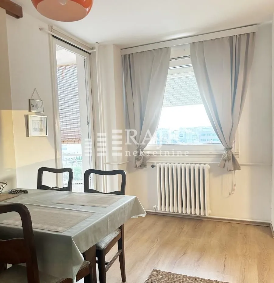 Living room with a dining table and window.