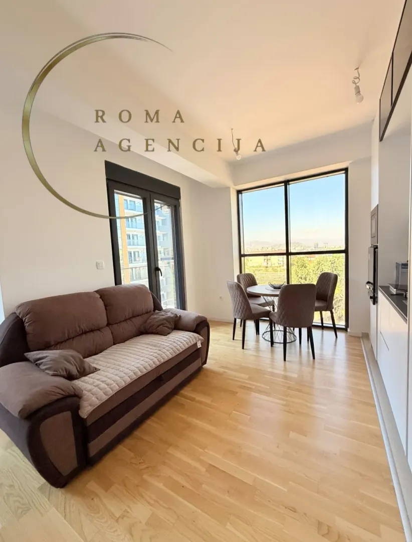 Living room with sofa and dining area.