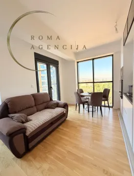 Living room with sofa and dining area. - image 2