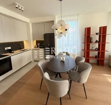 Modern dining area and kitchen with a dining table and chairs. - image 2