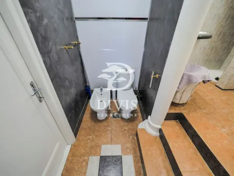 Bathroom equipped with a toilet, bidet, and ceramic tiles. - image 20