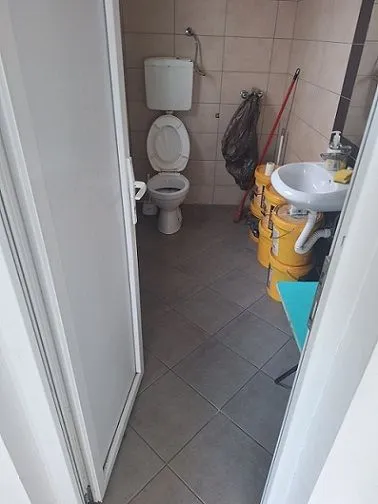 Small bathroom with a toilet, sink and tiles.