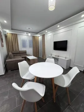 Living room with sofa, dining table and TV. - image 4