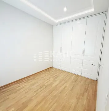 Empty bedroom with a built-in wardrobe and wooden flooring. - image 3
