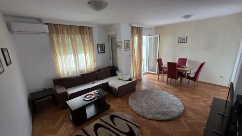 Bright living room with a seating area and a dining table. - image 13