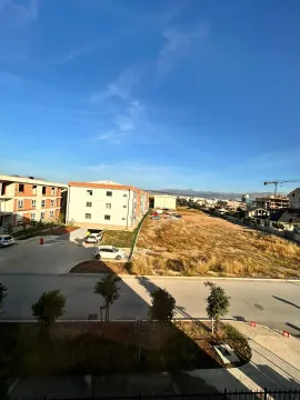 Pogled sa prozora na okolne zgrade, ulicu i brda u daljini. - image 2