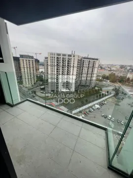 View from the balcony overlooking surrounding buildings and cityscape. - image 10