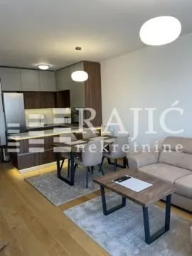 Modern living room with dining area and kitchen in the background. - image 2