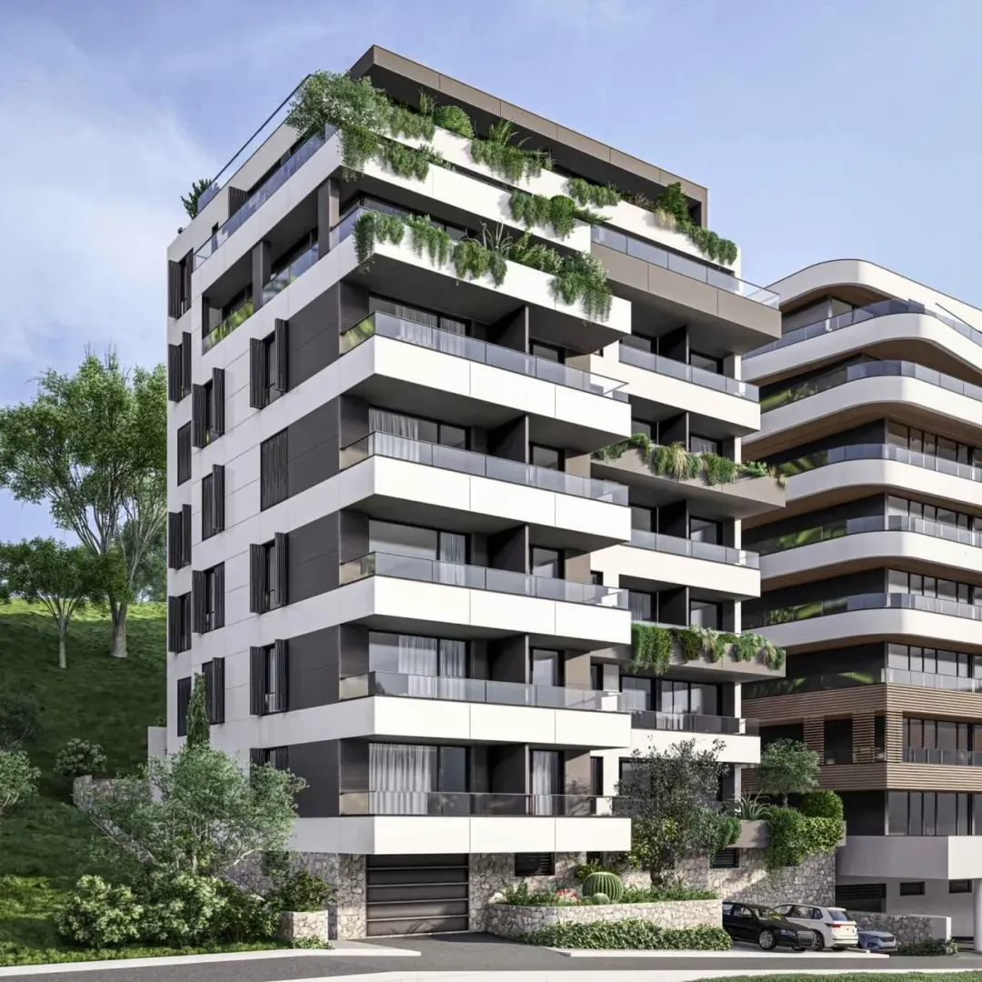Spoljašnji izgled moderne stambene zgrade sa terasama i zelenilom.