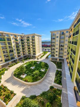 High-angle view of the courtyard and residential building facade with landscaped greenery. - image 10