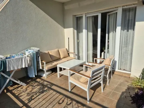 Terrace with seating furniture and a clothes drying rack. - image 18