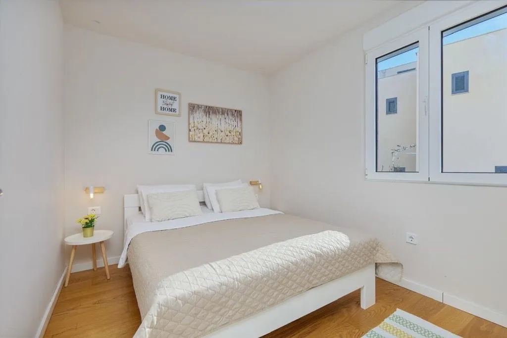 Bright bedroom with a double bed and a window.