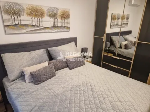 Bedroom with a double bed, large mirrored wardrobe, and an art painting on the wall. - image 11