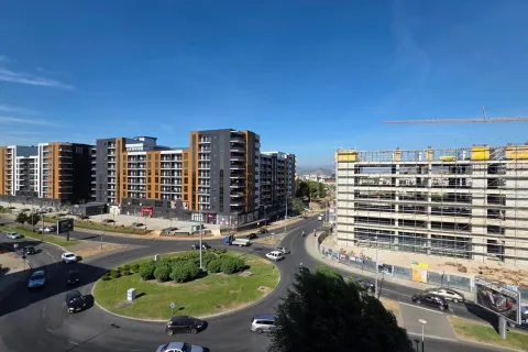 View from the terrace of a city street and roundabout with new buildings under construction. - image 16