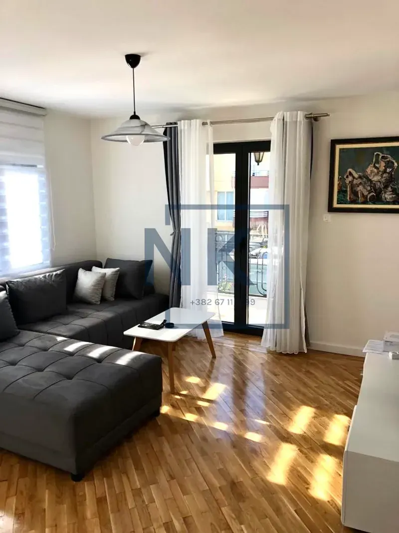 Living room with a sectional sofa, coffee table, and access to the terrace.