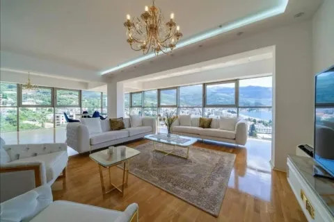 Spacious living room with large windows and a sea view. - image 3