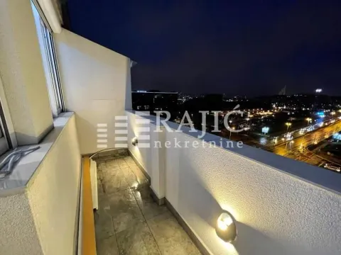 Covered balcony with a night view of the city. - image 6