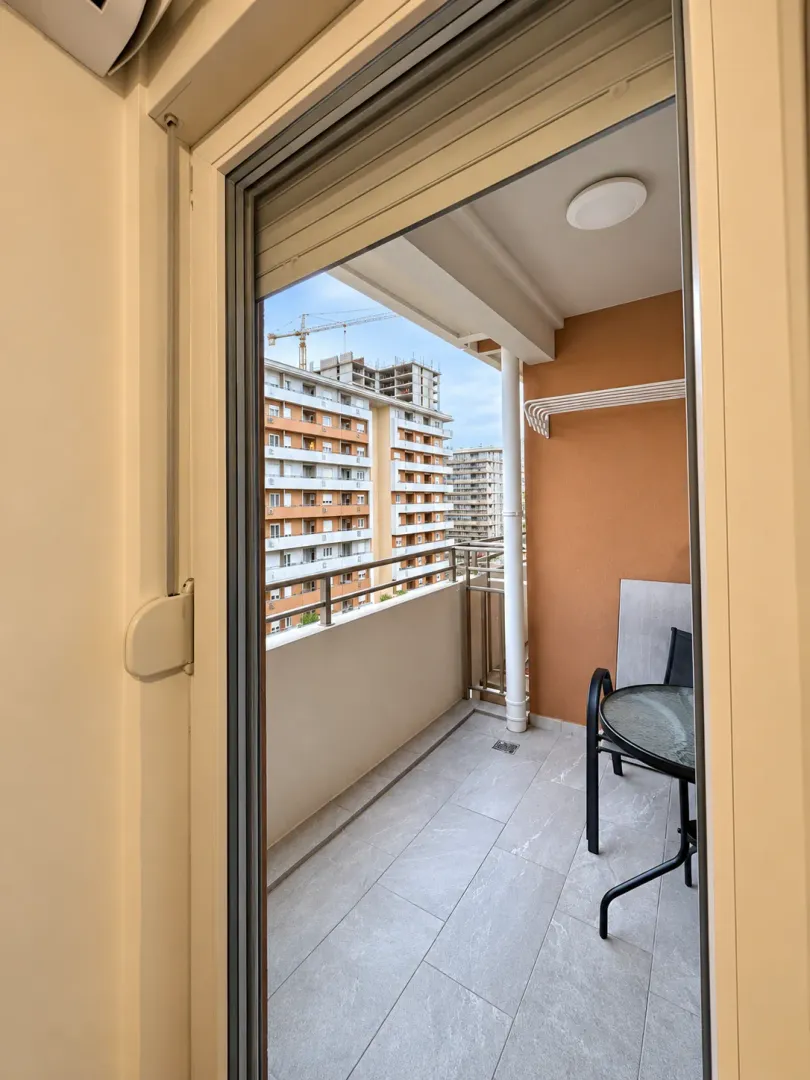 View from the balcony overlooking surrounding residential buildings.