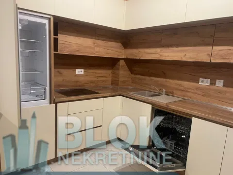Corner kitchen with wooden cabinets and built-in appliances. - image 8