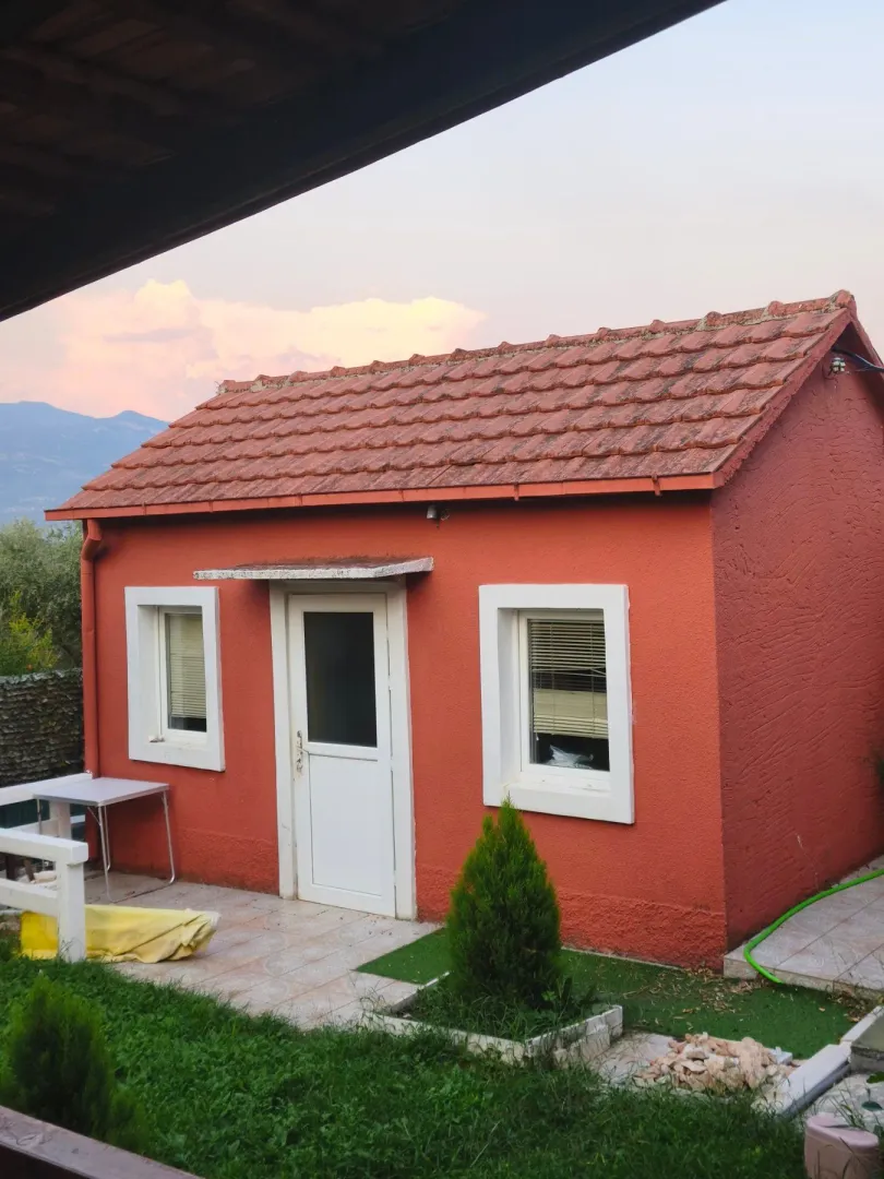 Exterior of a small house with a yard.
