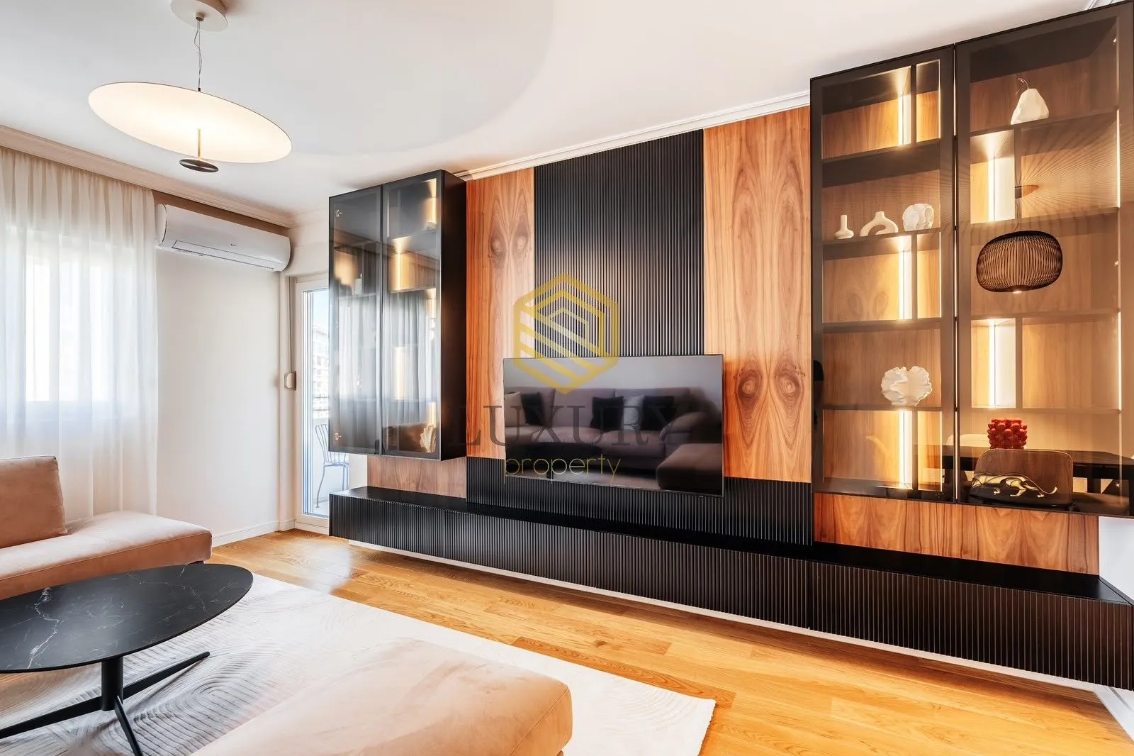 Modern living room with built-in cabinets and a TV panel.