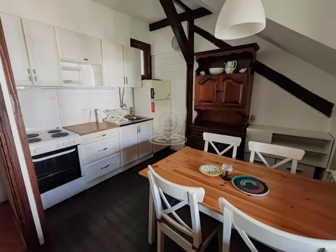 Kitchen with dining area and exposed wooden ceiling beams. - image 5