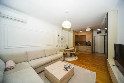 Living room with sofa, dining area, and kitchen in the background. - image 3