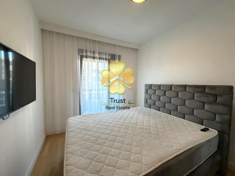 Modern bedroom with a double bed and a wall-mounted TV. - image 10