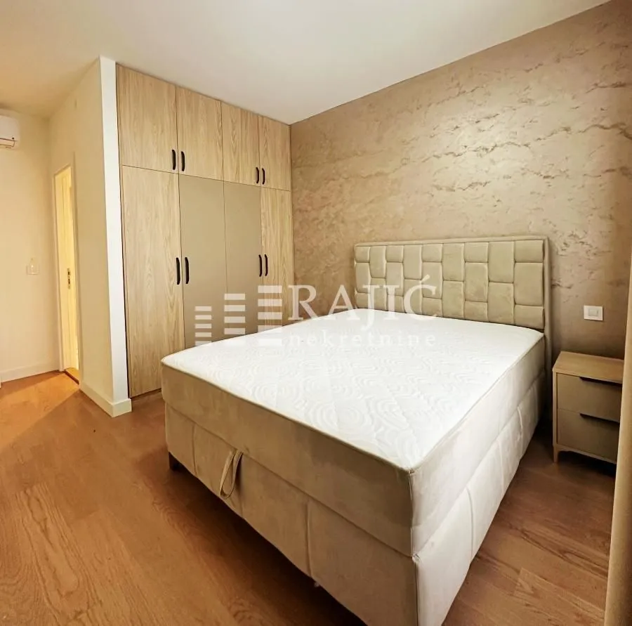 Furnished bedroom with a double bed and built-in wardrobe.