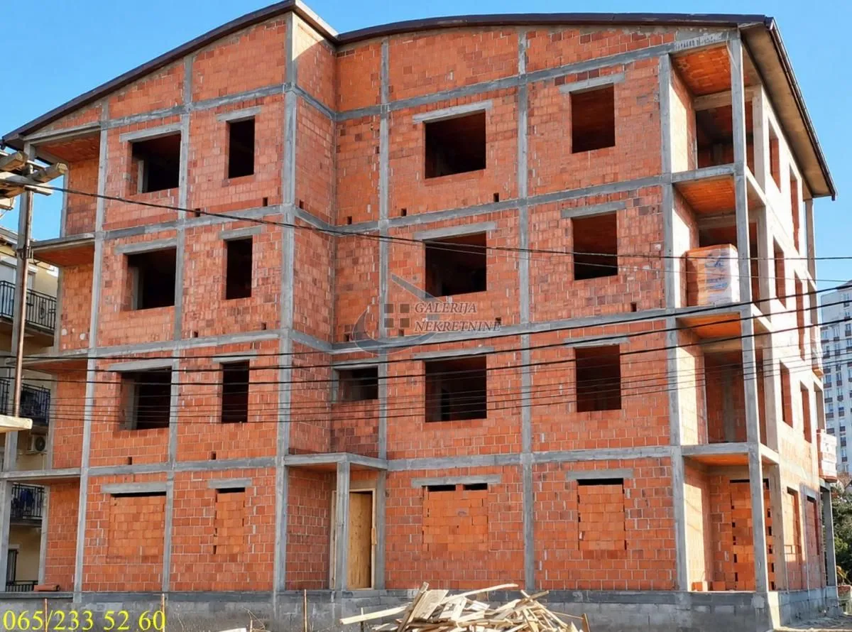 Exterior view of a residential building under construction with brickwork.