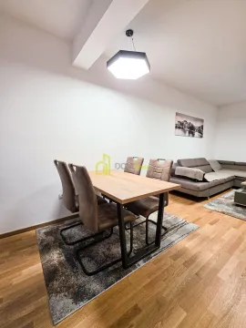 Living room with a dining table and sofa. - image 8