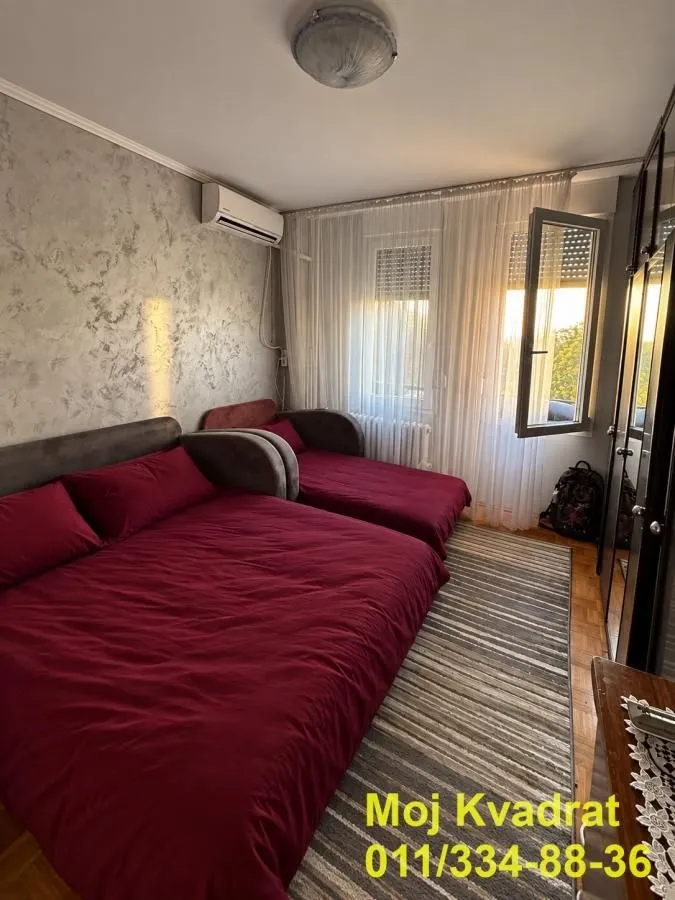 Furnished bedroom with two beds and access to the terrace.