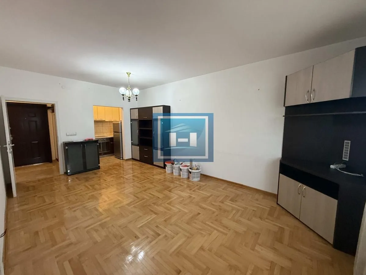 Living room with parquet flooring and furniture.