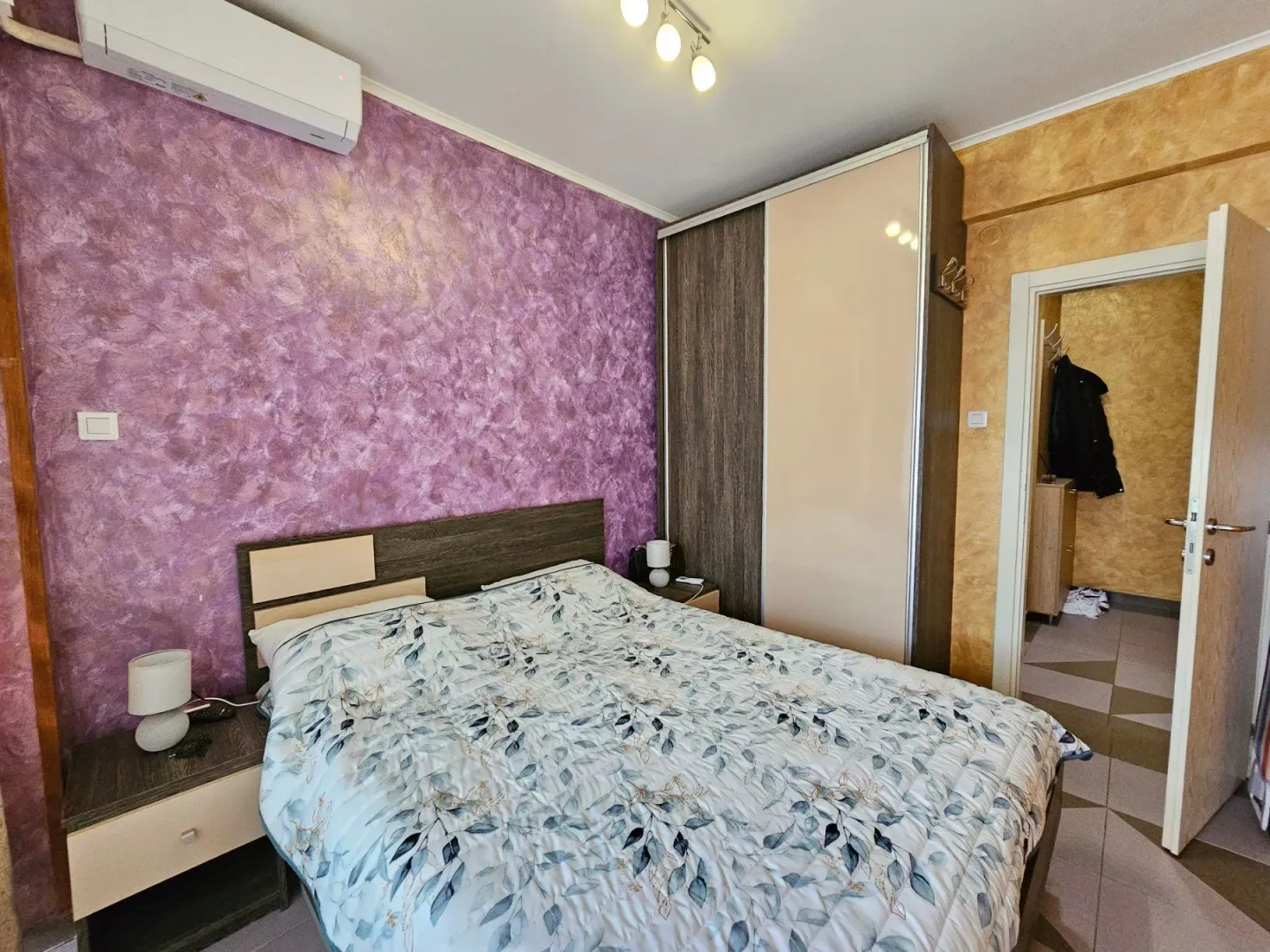 Furnished bedroom with a double bed, wardrobe, and nightstands.