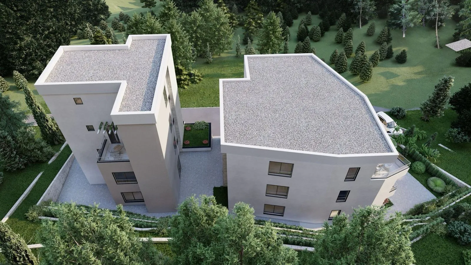 Pogled iz vazduha na moderne stambene zgrade okružene zelenilom.