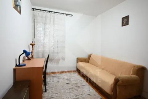 Small room with a pull-out sofa, a desk, and a window. - image 7