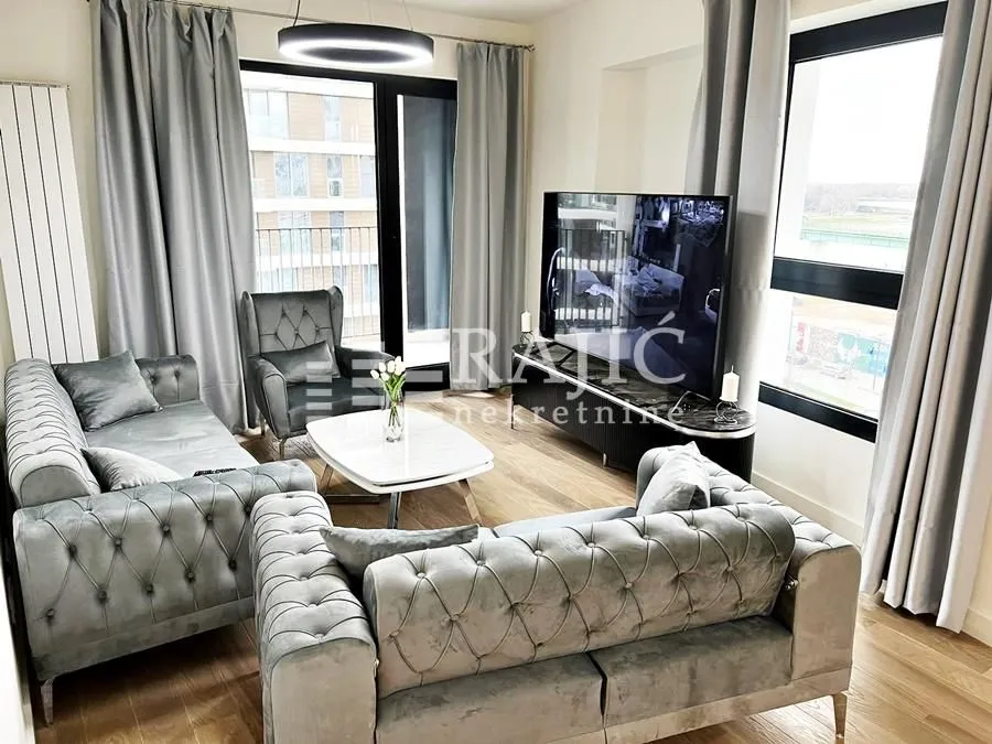 Modern and bright living room with a sofa set and large windows.