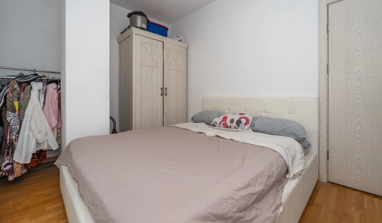 Bedroom with a double bed, wardrobe, and open closet.