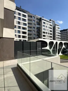 View of the exterior of a modern residential building with a balcony and glass railing. - image 2