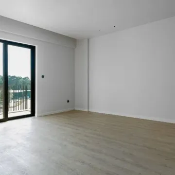 Prazna svijetla prostorija sa parketom i izlazom na balkon. - image 6