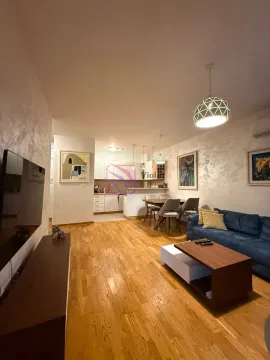 Living room with sofa, TV, dining area and kitchen in the background. - image 4