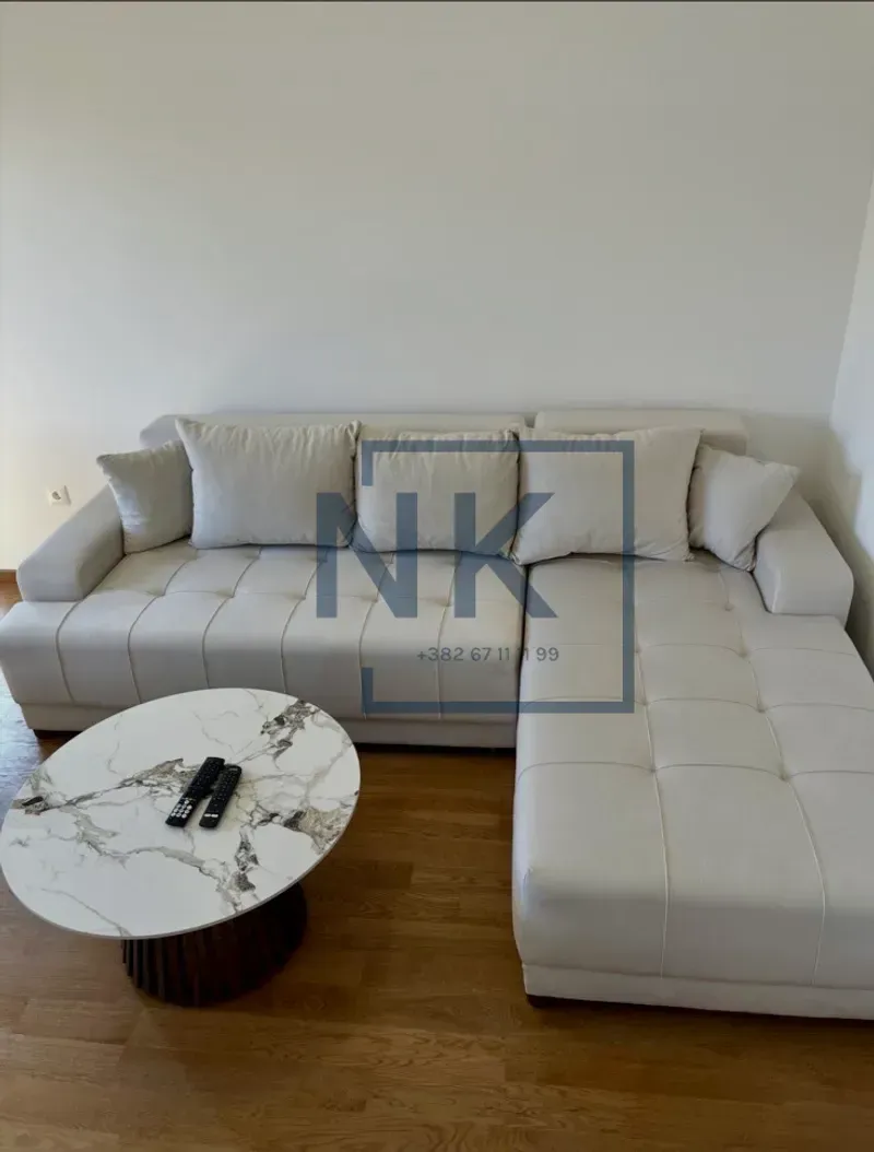 Corner sofa in the living room with a round coffee table.