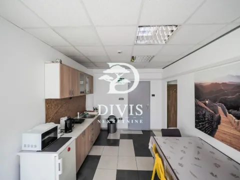 Kitchen with a dining table and built-in units. - image 13