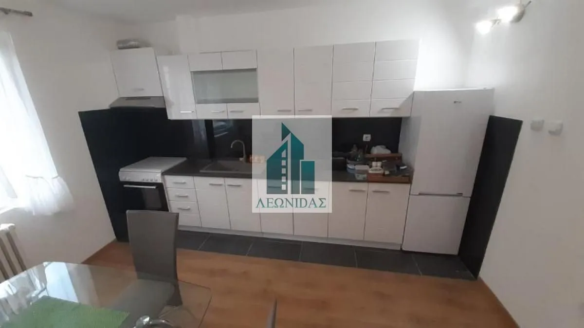 Kitchen equipped with white cabinets and white appliances.