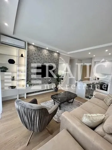 Modern and bright living room with a sofa and dining area in the background.