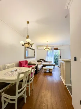 Living room with dining area, wooden flooring, and access to the terrace. - image 3