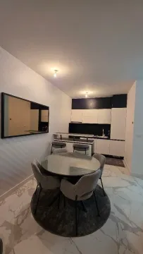 Modern kitchen with a dining area and breakfast bar. - image 5